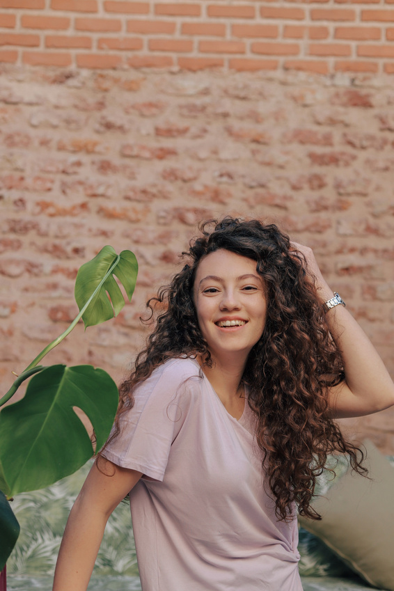 Woman Posing Near Monstera Plant